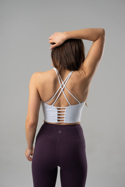 Black Alyth Active Rebellious Crop Bra shown on a small-sized model, highlighting its sporty design and comfortable fit.