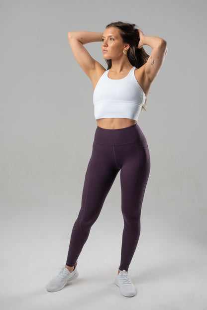 Black Alyth Active Rebellious Crop Bra shown on a small-sized model, featuring athletic design and supportive fit.