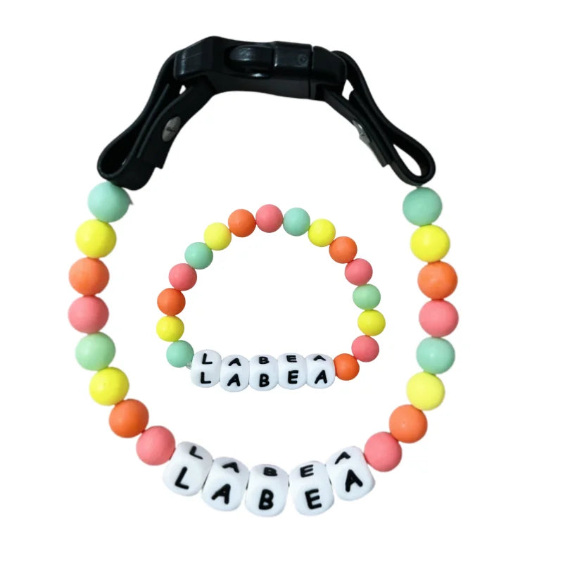 Personalized PawBond pet collar and matching bracelet set with paw print design, adjustable for pets and stylish accessories.