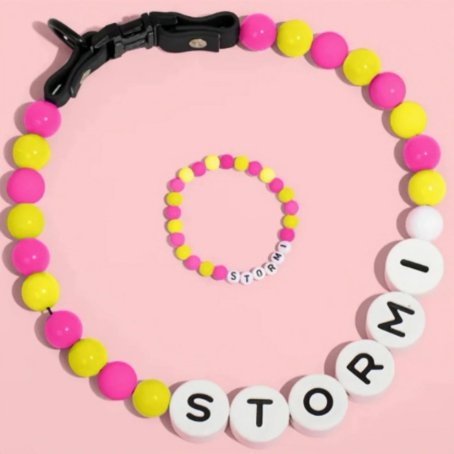 Personalized PawBond pet collar with matching bracelet set, featuring colorful adjustable straps and paw print design.