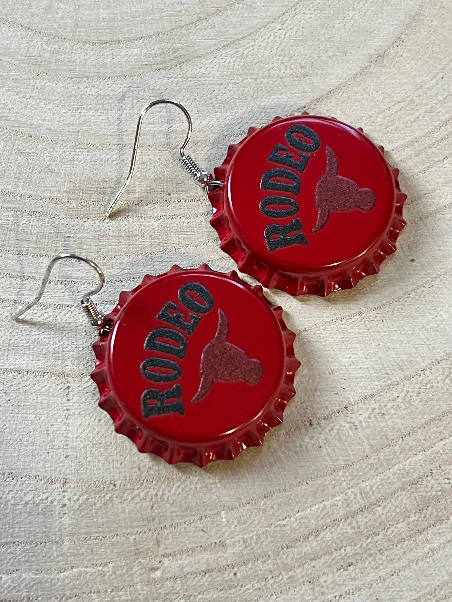 Western Rodeo Steer Head Beer Cap Earrings featuring bull motif, Cowhide and Conchos fashion jewelry, western statement accessory.