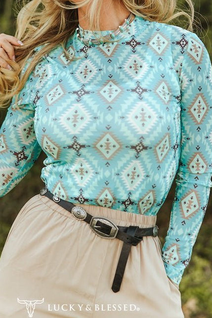 Women's turquoise Aztec print long sleeve mesh western top by Cowhide and Conchos with bold Southwestern geometric design.