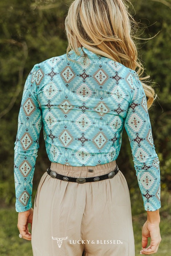 Women’s turquoise Aztec print long sleeve mesh western top by Cowhide and Conchos with bold Southwestern geometric design.