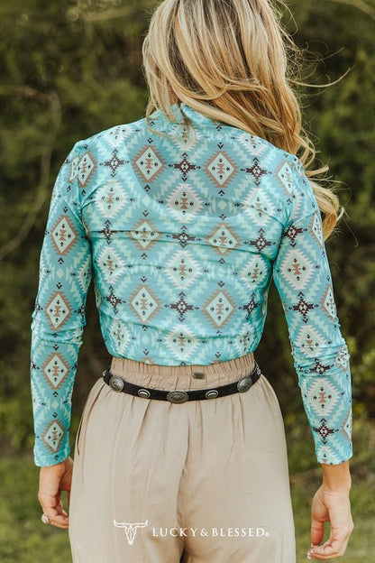 Women’s turquoise Aztec print long sleeve mesh western top by Cowhide and Conchos with bold Southwestern geometric design.