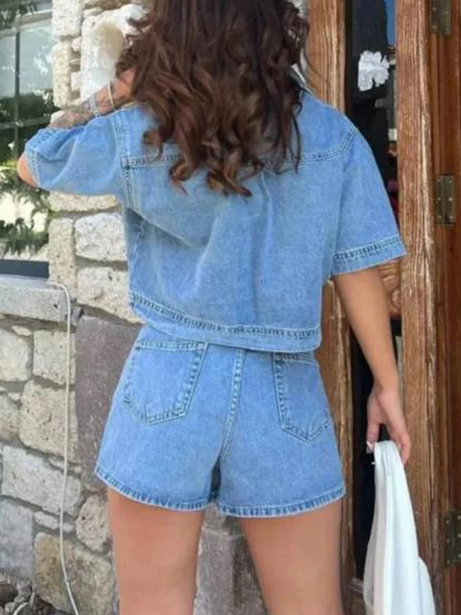 Women’s 2-piece denim streetwear set with short sleeve lapel jean top and asymmetrical denim shorts, stylish casual outfit.