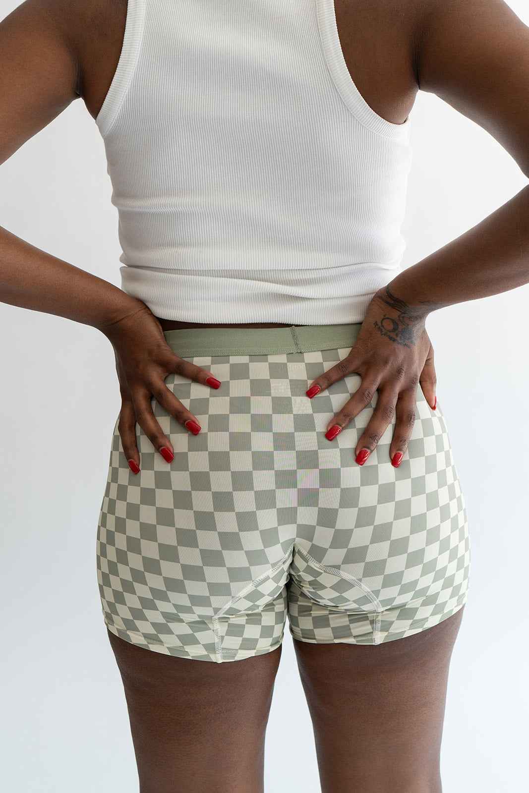 Black boxer briefs from Monthly, close-up of the snug fit and smooth fabric in a natural pose.