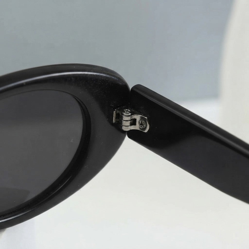 Black oval sunglasses with UV protection from Redemption by Ashley North, featuring a sleek, one-size design.