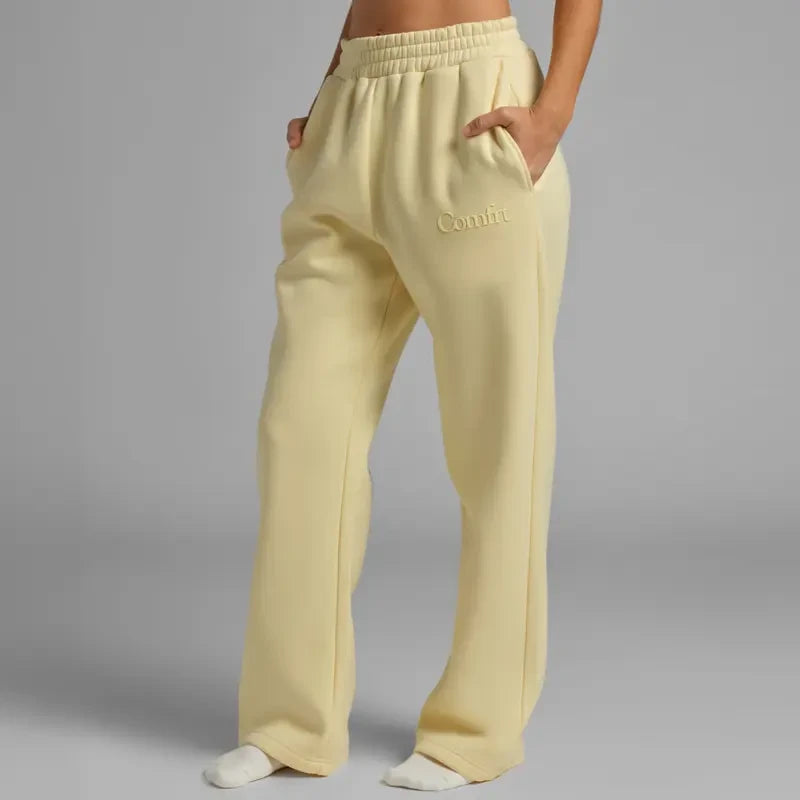 Chocolate milk-colored minimalist straight-leg sweatpants by Redemption by Ashley North, showing relaxed fit and soft fabric.