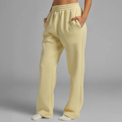 Chocolate milk-colored minimalist straight-leg sweatpants by Redemption by Ashley North, showing relaxed fit and soft fabric.