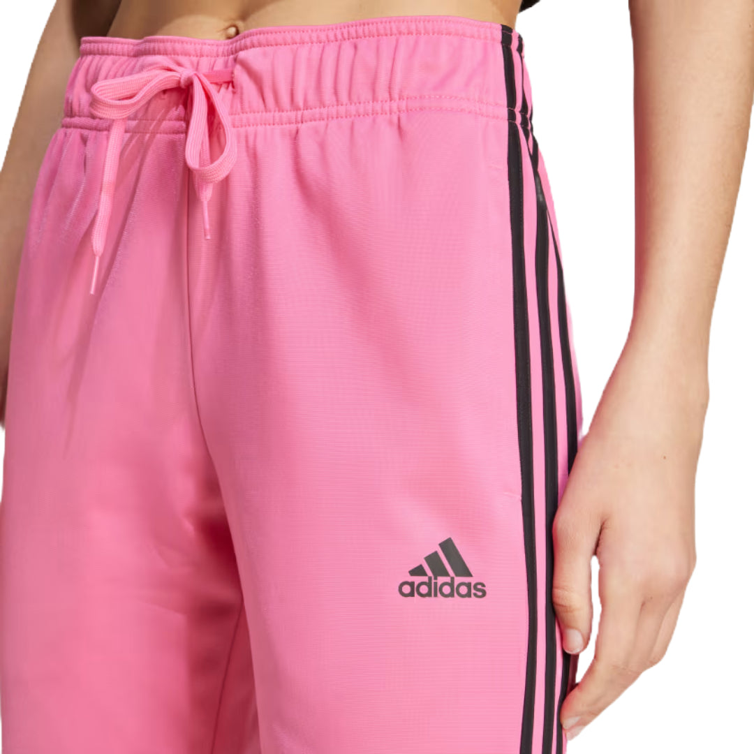 Runnwalk women's adidas Primegreen Essentials warm-up slim tapered track pants in Pulse Magenta, featuring 3-stripes and tapered fit.