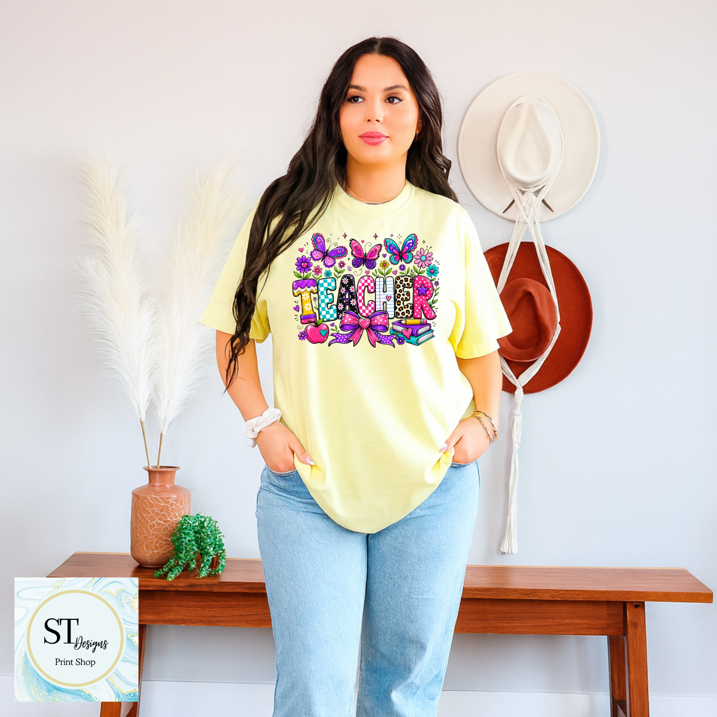 Colorful teacher graphic crewneck sweatshirt by ST Designs Store, featuring vibrant educational-themed illustrations on a sand-colored fabric.