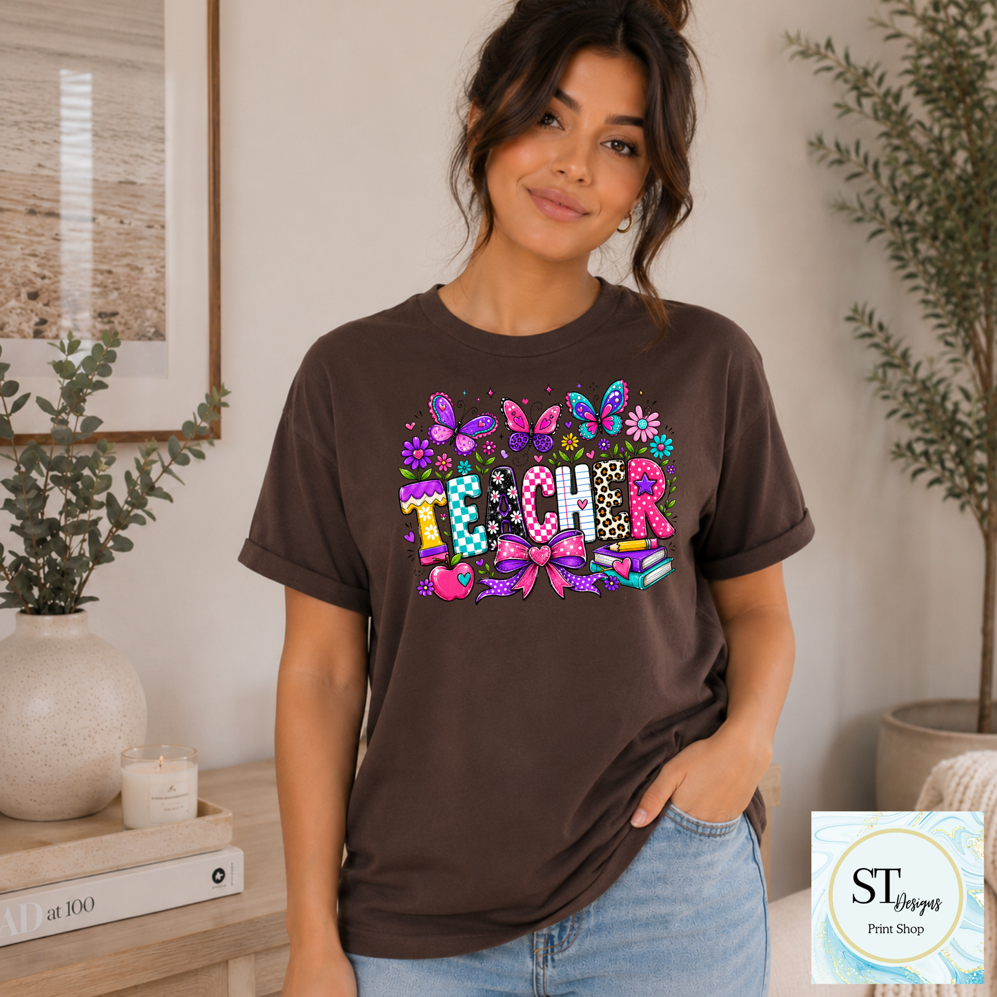 Colorful teacher graphic crewneck sweatshirt in sand color with vibrant educational-themed design by ST Designs Store.