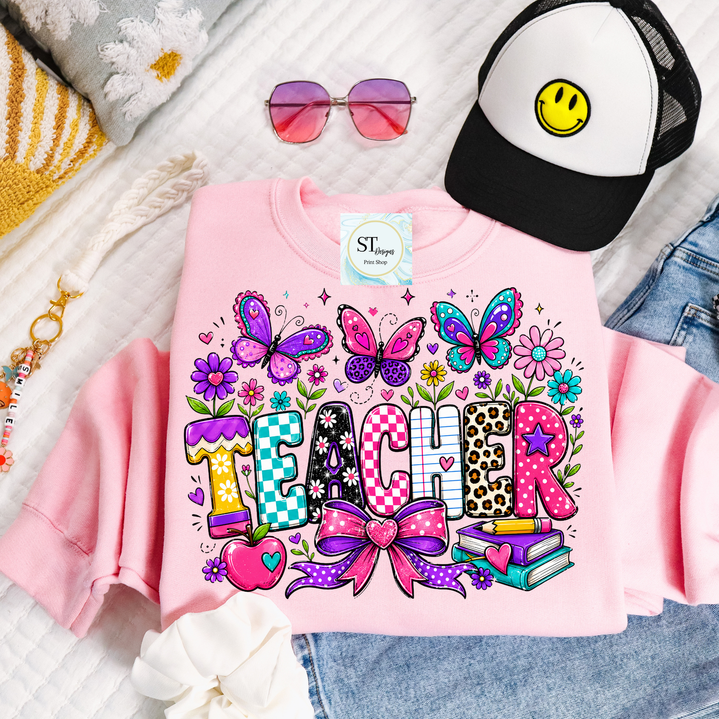 Colorful teacher graphic crewneck sweatshirt in sand color with vibrant educational-themed design by ST Designs Store