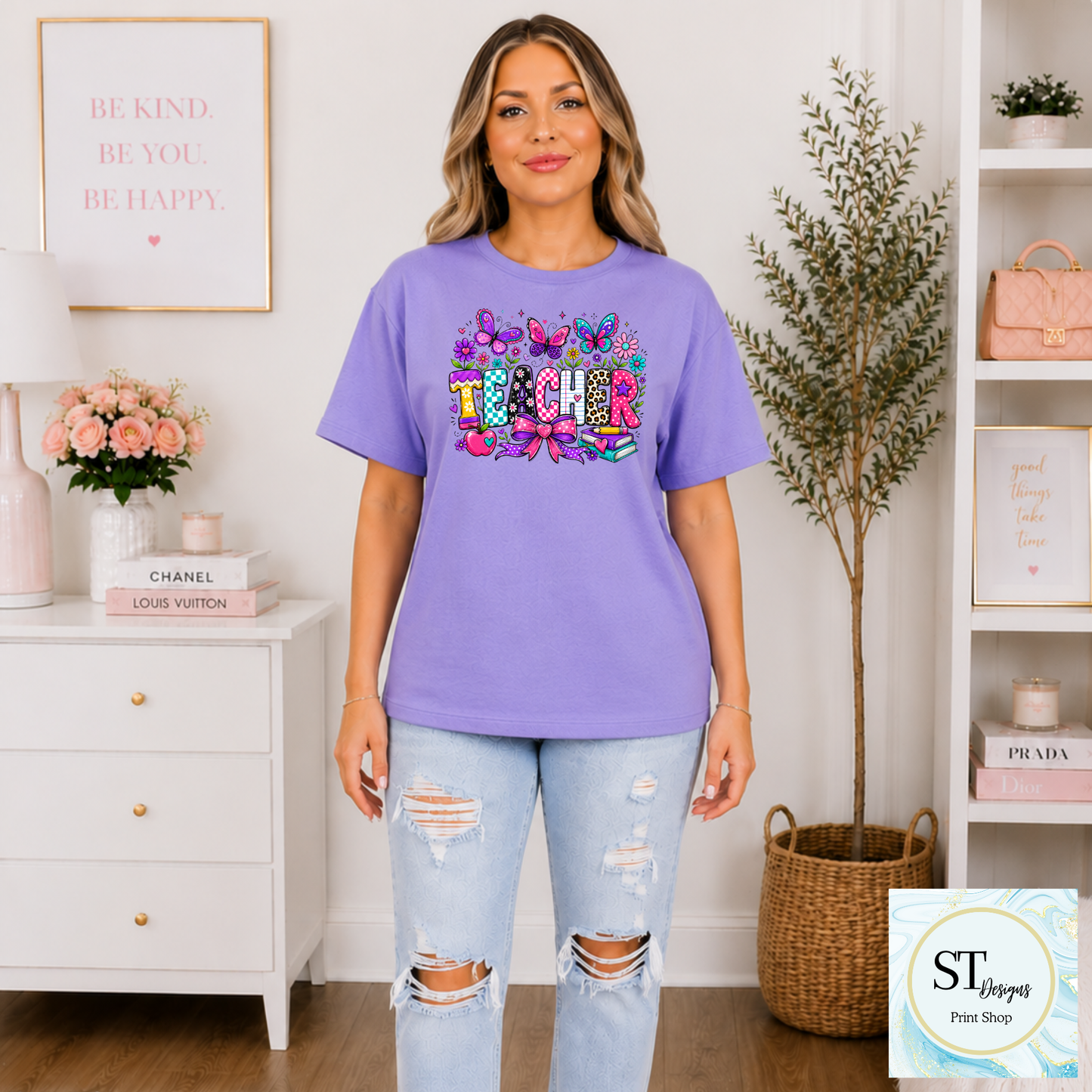 Colorful teacher graphic crewneck sweatshirt by ST Designs Store, featuring vibrant print on a sand-colored fabric.