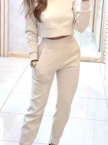 Casual chic cropped sweatshirt and jogger set by Trendsi, featuring a relaxed fit in soft fabric with stylish details.