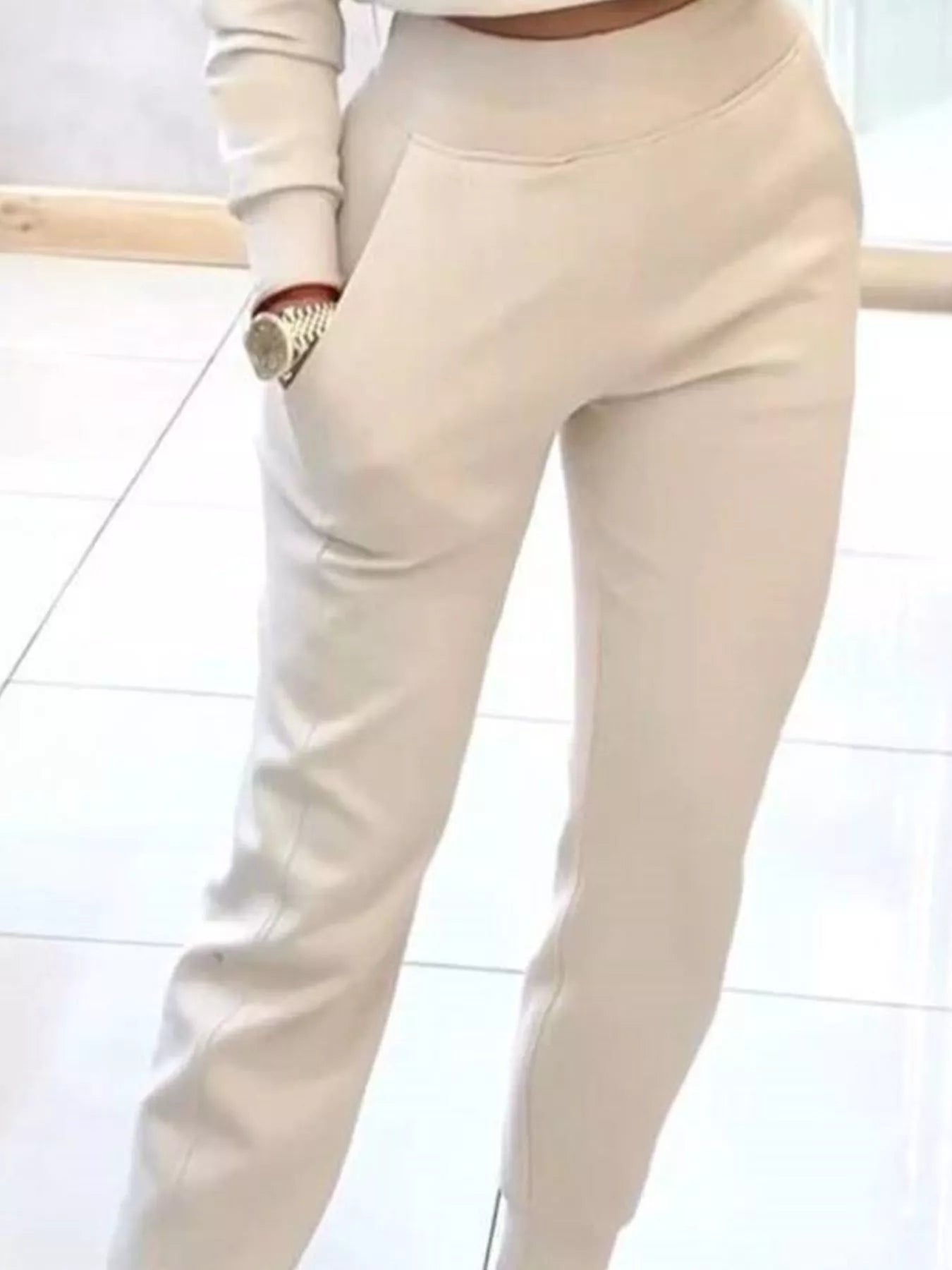 Casual chic cropped sweatshirt and jogger set by Trendsi, featuring a relaxed fit and comfortable fabric in neutral tones.
