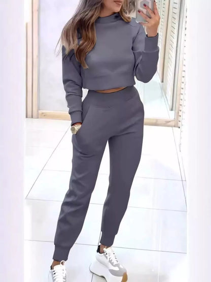 Casual chic cropped sweatshirt and matching jogger set by Trendsi, featuring comfortable fabric and stylish fit.