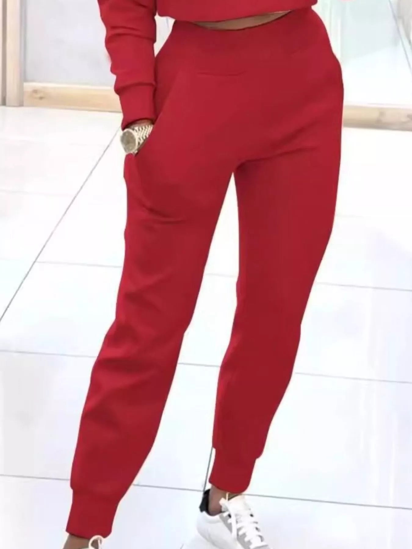 Casual chic cropped sweatshirt and matching jogger pants set by Trendsi, featuring a relaxed fit and stylish comfort.