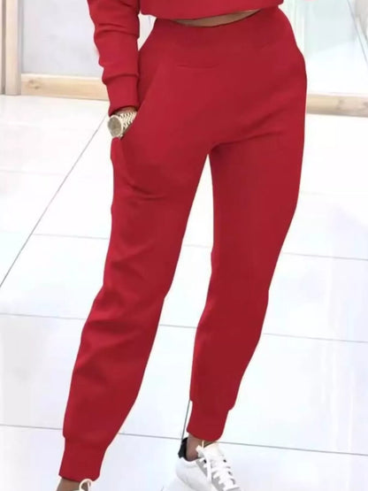 Casual chic cropped sweatshirt and matching jogger pants set by Trendsi, featuring a relaxed fit and stylish comfort.