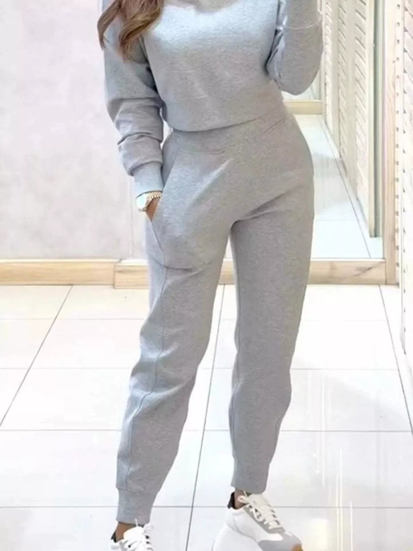 Casual Chic cropped sweatshirt and jogger set by Trendsi, featuring comfortable fabric and stylish fit for relaxed everyday wear.