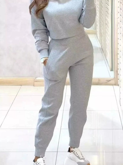 Casual Chic cropped sweatshirt and jogger set by Trendsi, featuring comfortable fabric and stylish fit for relaxed everyday wear.