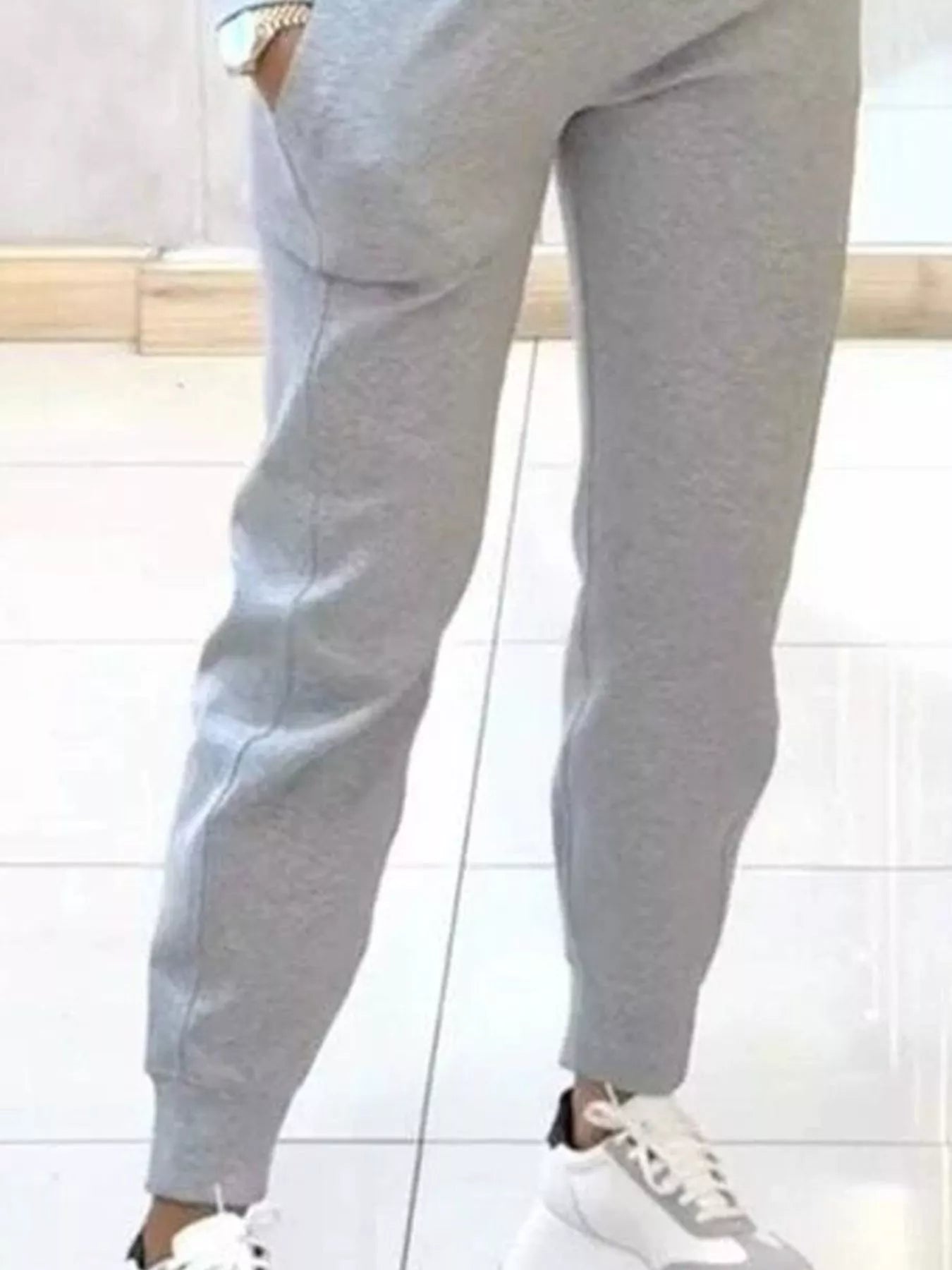 Casual Chic Cropped Sweatshirt and Jogger Set by Trendsi, featuring a cozy cropped sweatshirt and matching joggers in a stylish casual look.