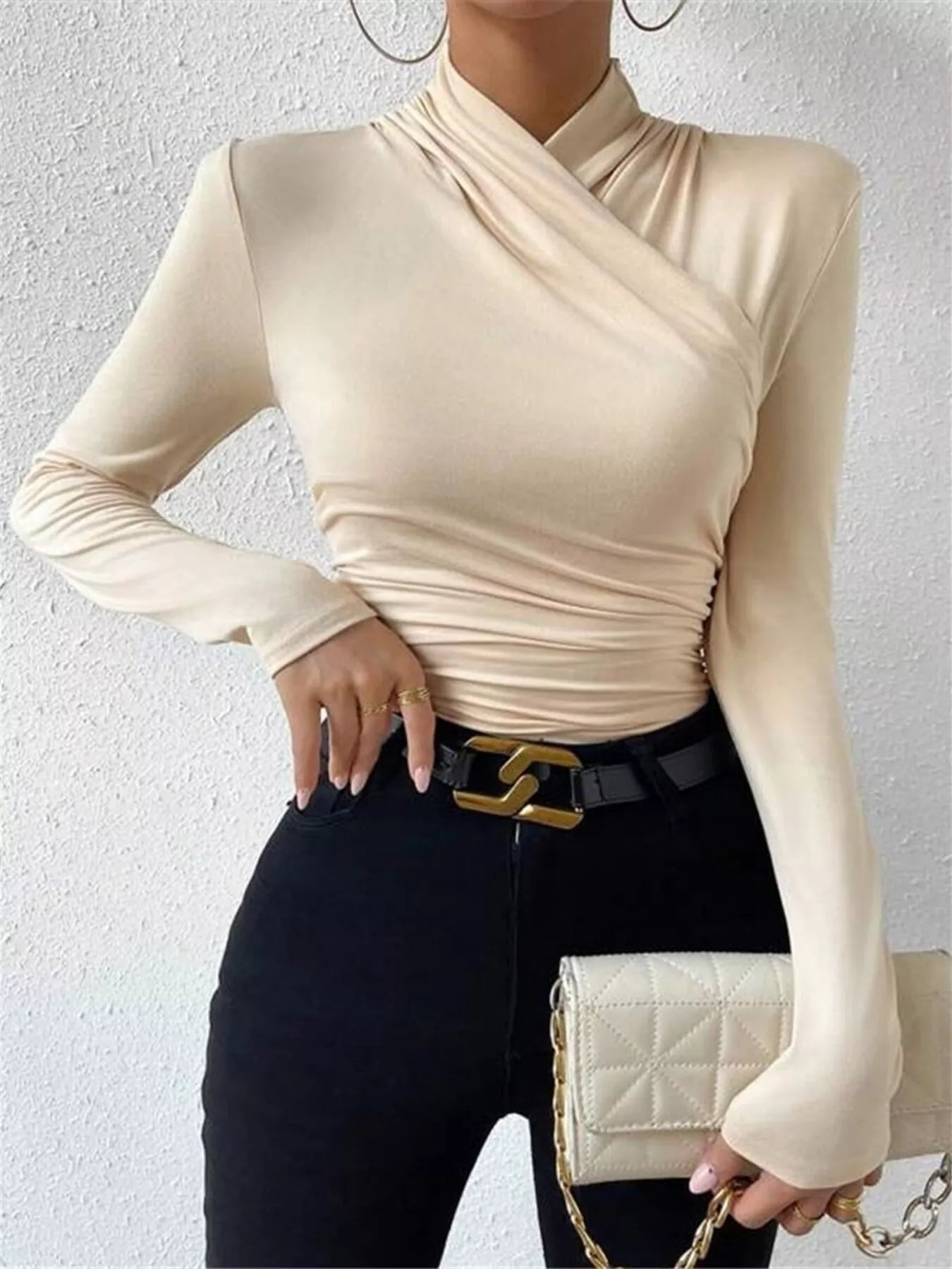 Black ruched long sleeve slim fit top by Trendsi, featuring gathered fabric and a sleek, fitted design.
