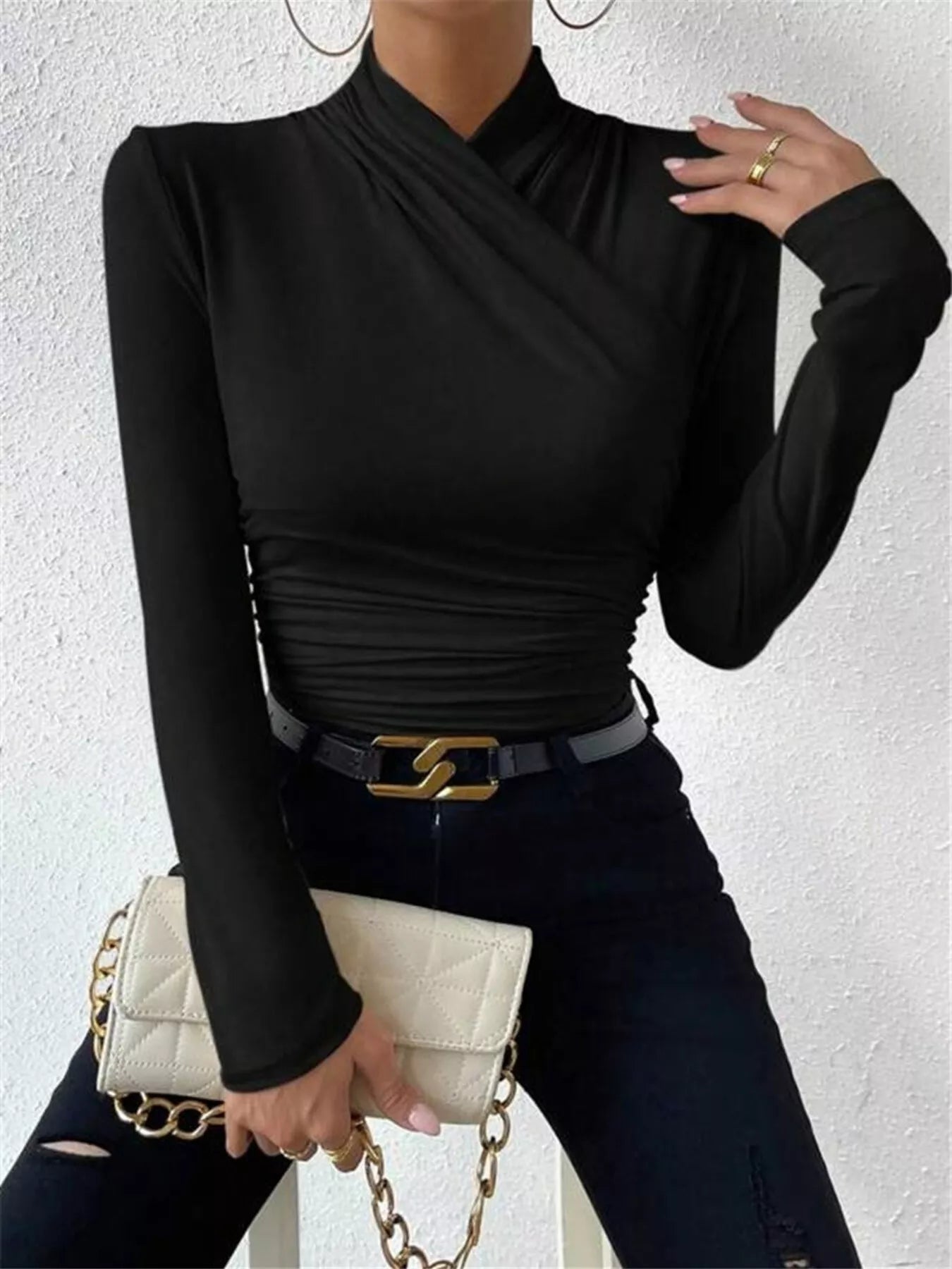 Black ruched long sleeve slim fit top by Trendsi, featuring a fitted design with ruched detailing on the sleeves.