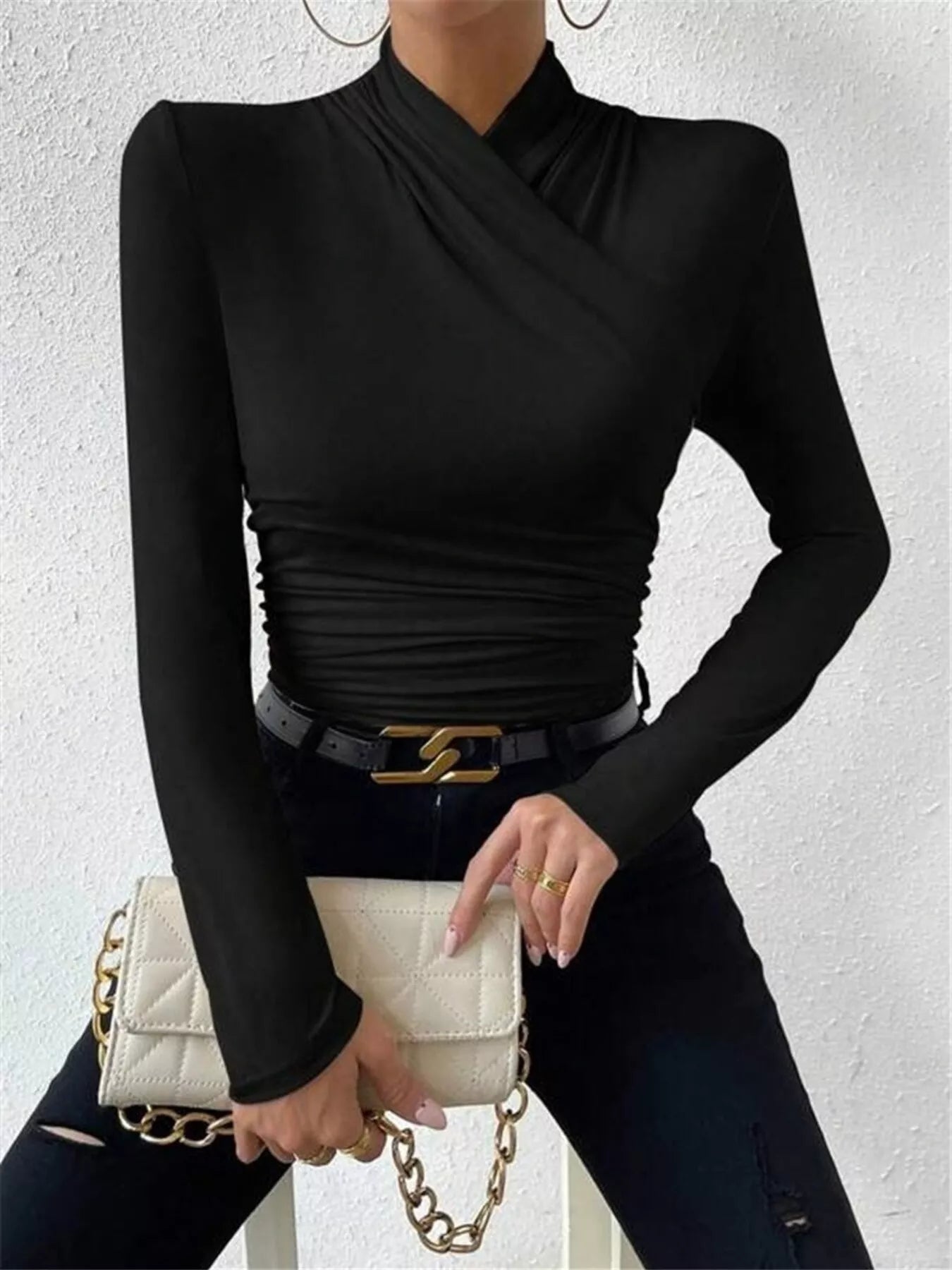 Black ruched long sleeve slim fit top from Trendsi, featuring a fitted design and stylish ruching details.