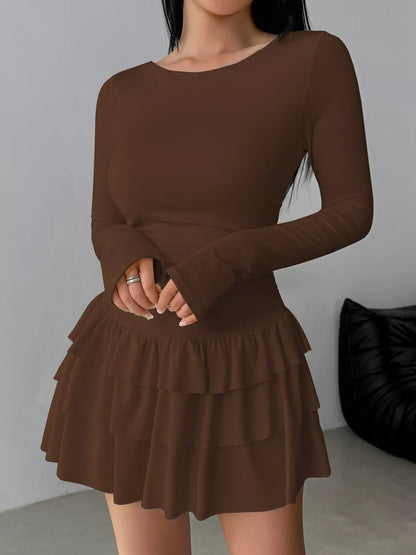 Ruched long sleeve layered ruffle mini dress by Trendsi, showing the dress's flowy fabric, ruffled details, and fitted silhouette.