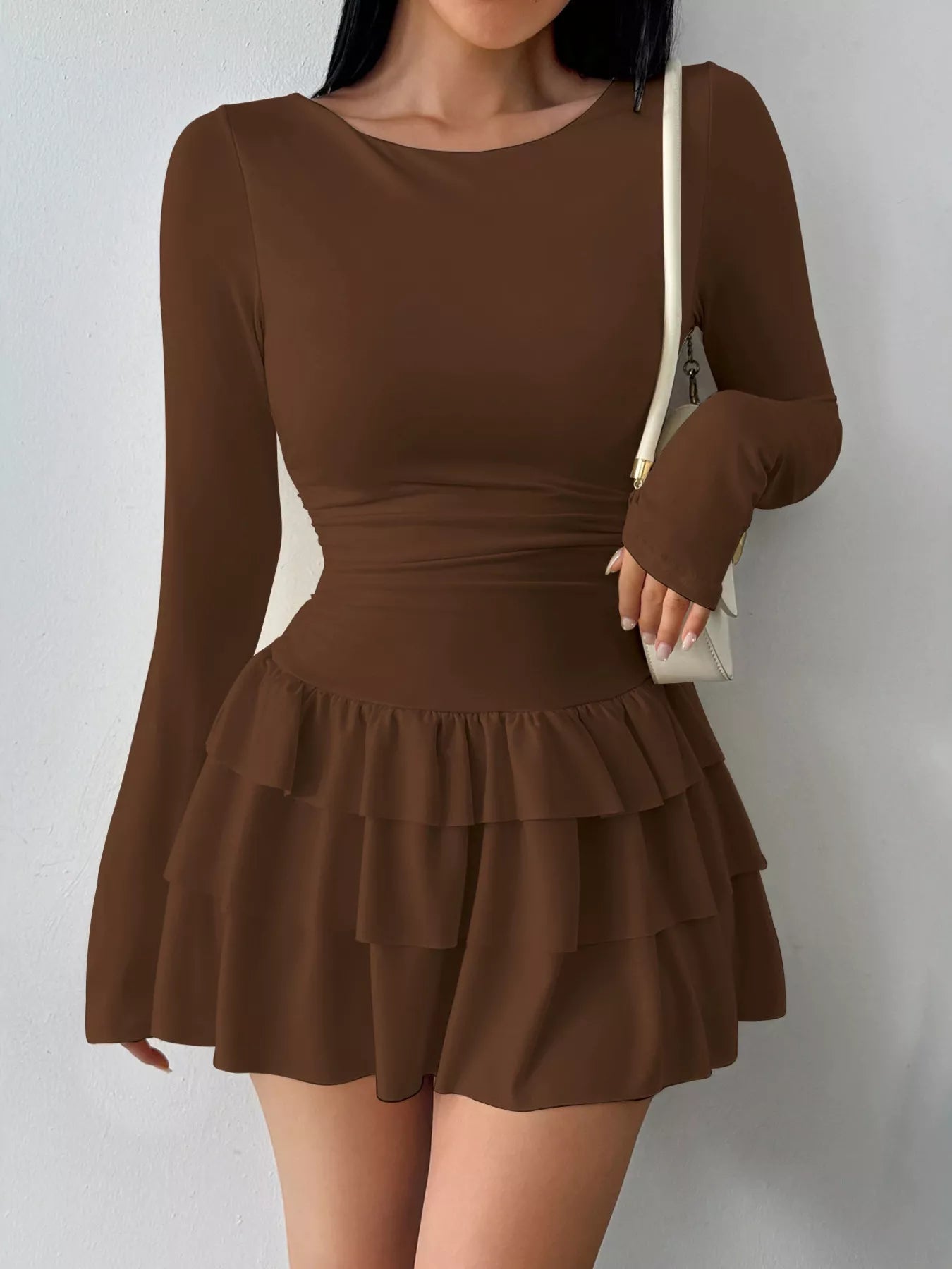 Ruched long sleeve layered ruffle mini dress from Trendsi, featuring a stylish design with ruffles and a fitted silhouette.