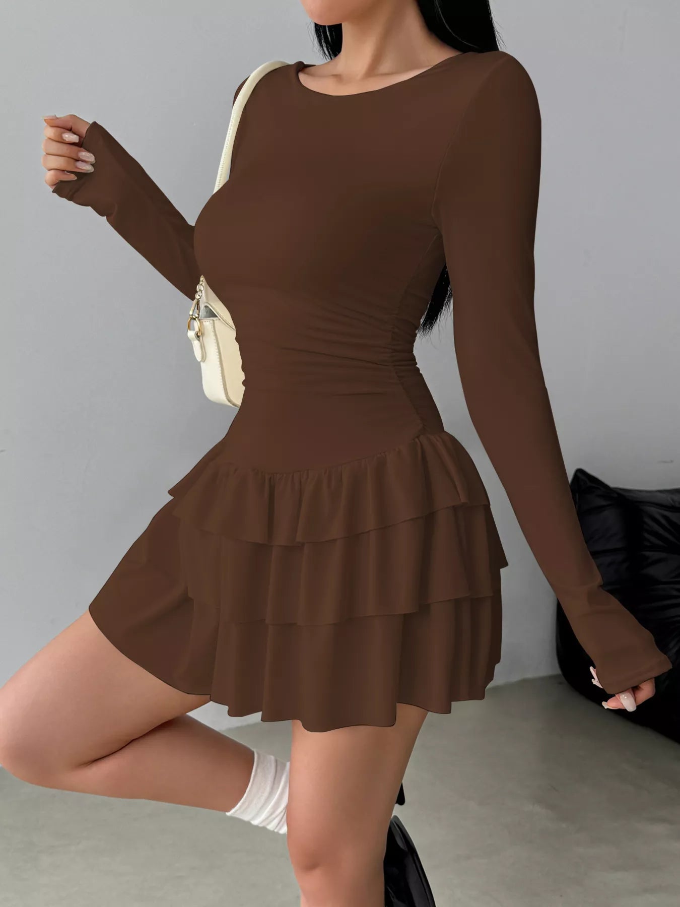 Ruched long sleeve layered ruffle mini dress by Trendsi, featuring a stylish design with ruffles and a fitted silhouette.