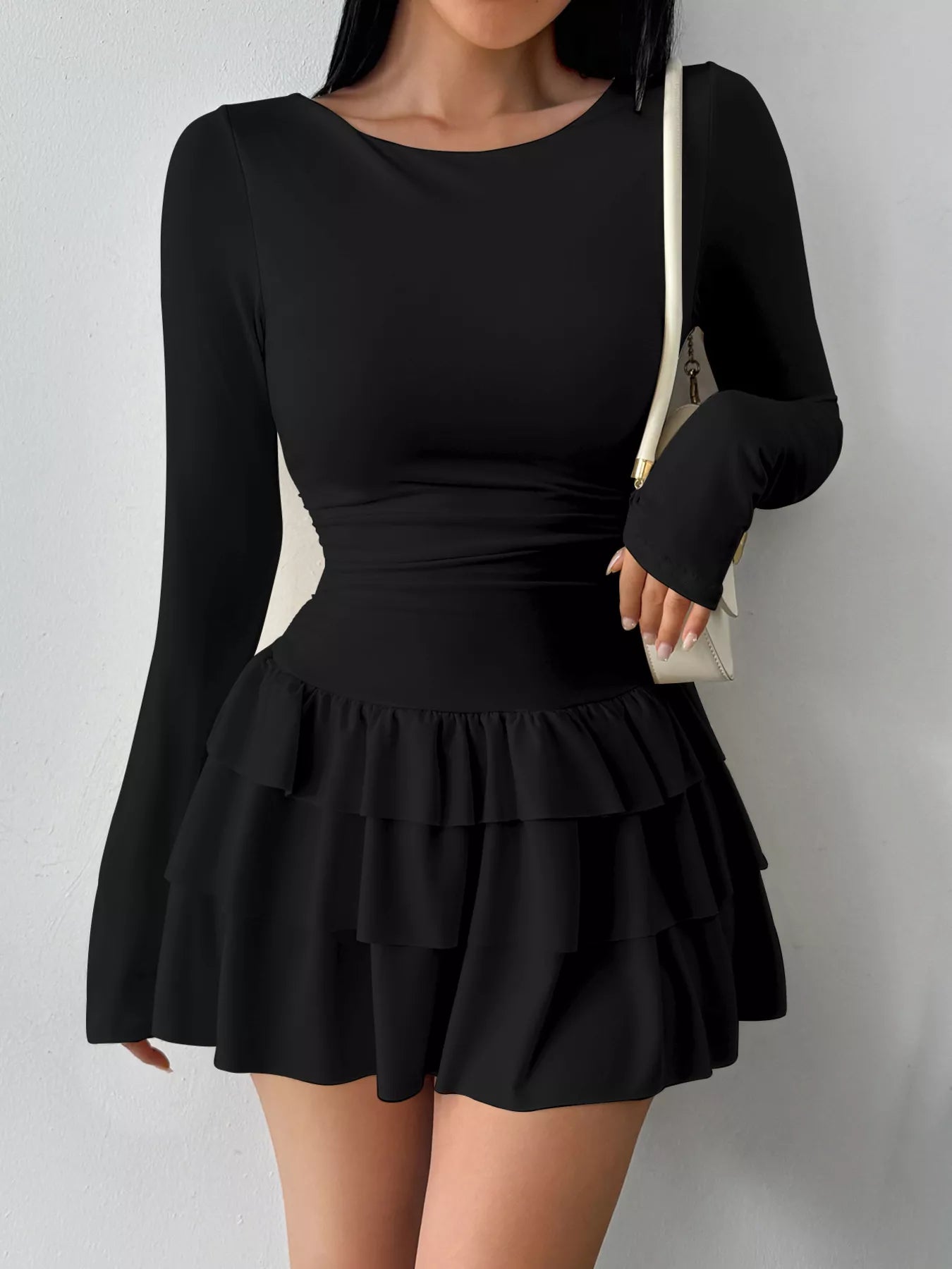 Ruched long sleeve layered ruffle mini dress by Trendsi, featuring a stylish design with ruffles and fitted long sleeves.