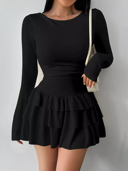 Ruched long sleeve layered ruffle mini dress by Trendsi, featuring a stylish design with ruffles and fitted long sleeves.