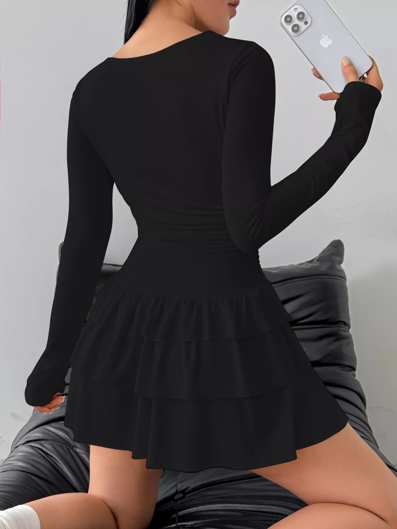 Ruched long sleeve layered ruffle mini dress by Trendsi featuring a stylish design with ruffles and a fitted silhouette.