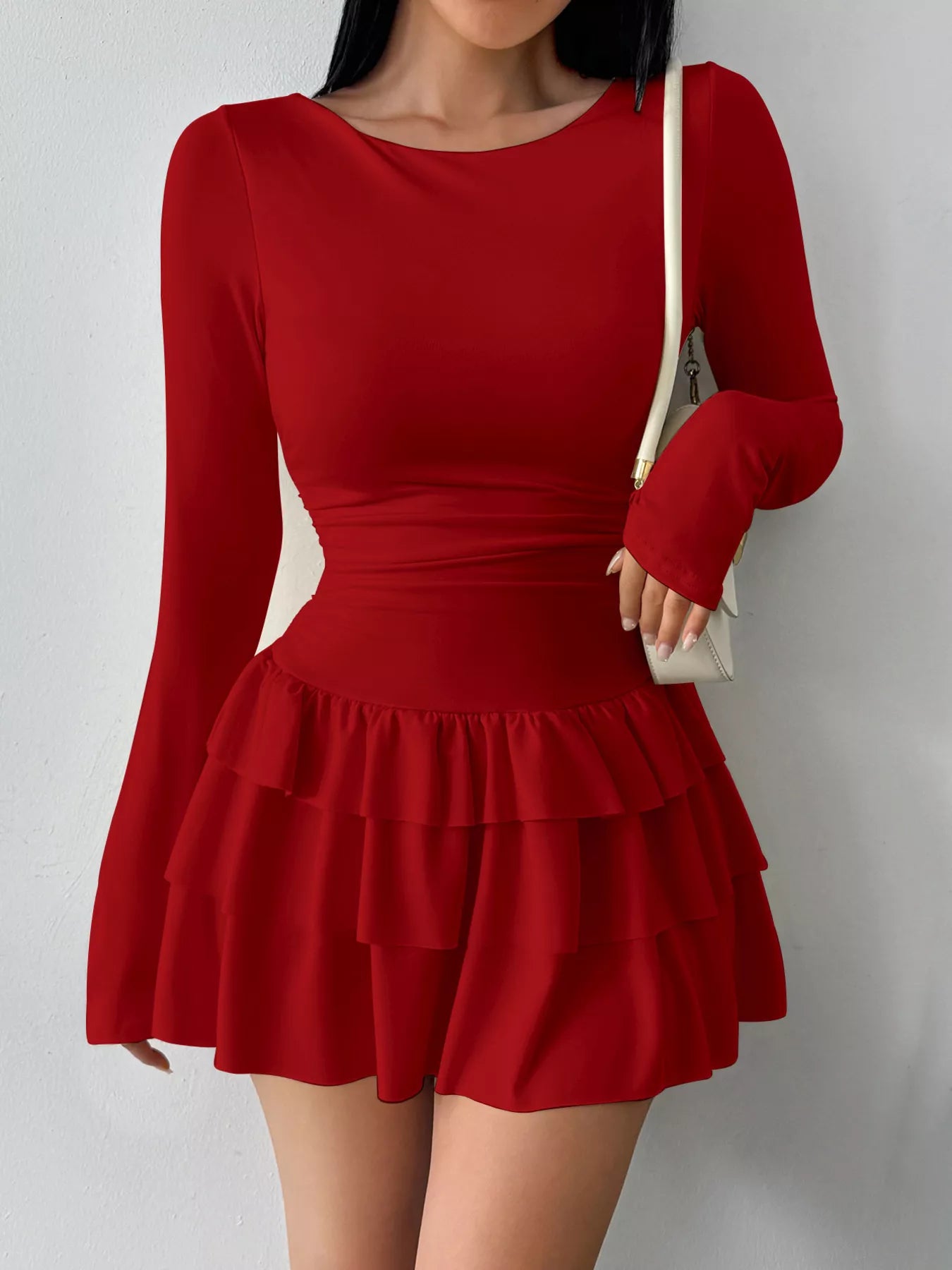 Ruched long sleeve layered ruffle mini dress from Trendsi featuring a stylish design and feminine ruffle details.