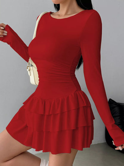 Ruched long sleeve layered ruffle mini dress by Trendsi, showcasing the textured fabric and stylish design details.