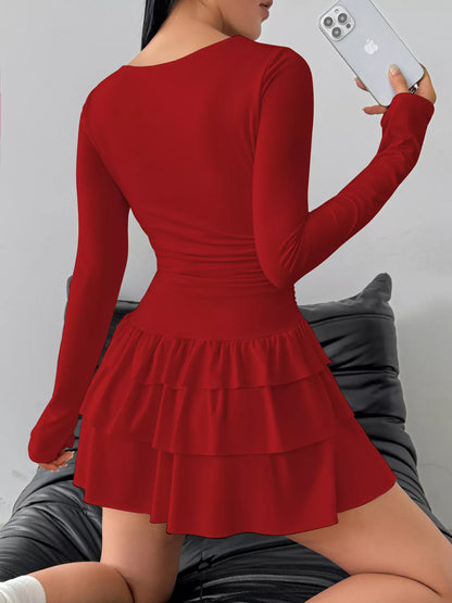 Ruched long sleeve layered ruffle mini dress by Trendsi, featuring a stylish design with ruffles and a fitted silhouette.