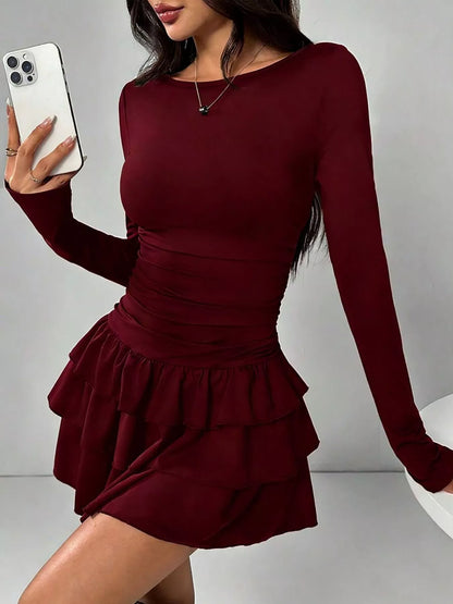 Ruched long sleeve layered ruffle mini dress by Trendsi, featuring a stylish design with ruffles and a fitted silhouette.