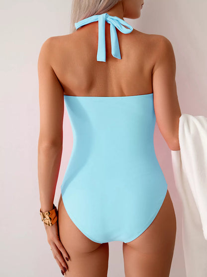 Trendsi twisted front halter neck ruched one-piece swimsuit displayed on a model, showcasing its stylish design and fit.