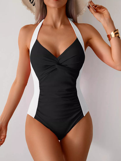 Twisted front halter neck ruched one-piece swimsuit by Trendsi, featuring a stylish design and flattering fit.