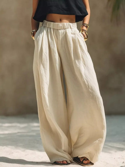 Beige plus size wide leg pants with full elastic waistband from Trendsi, featuring a relaxed fit and comfortable style.