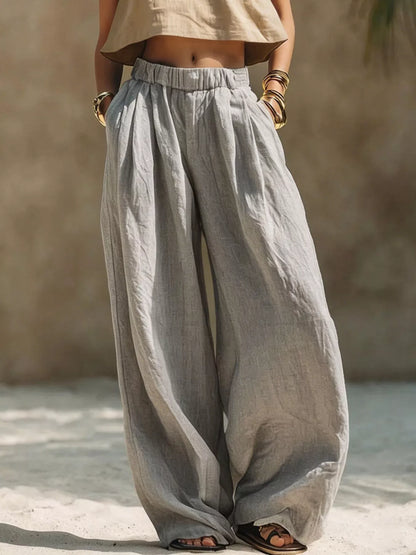 Plus size beige wide leg pants with elastic waistband from Trendsi, full-length, comfortable, and flowy for casual or office wear.