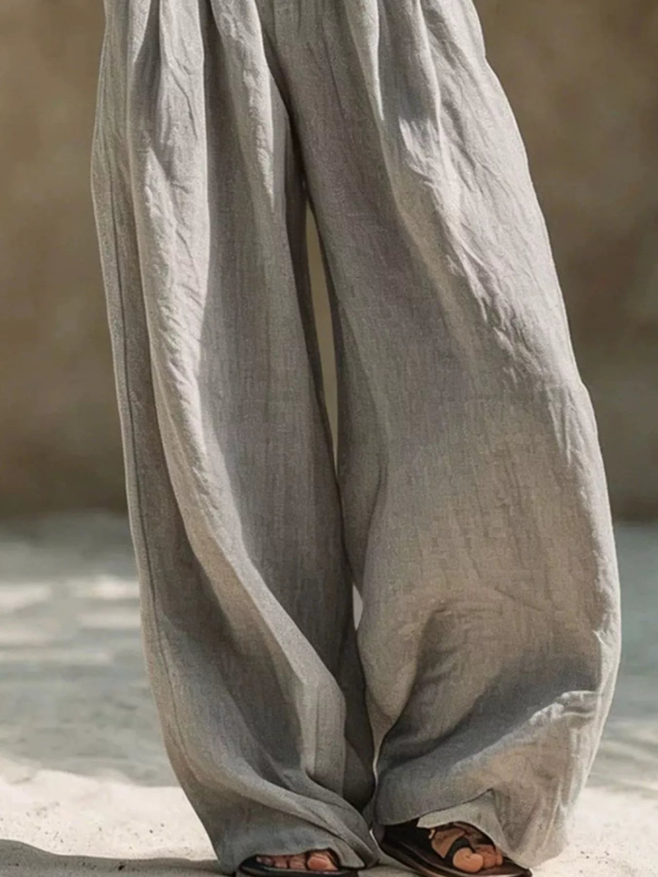 Plus size beige wide-leg pants with full elastic waistband from Trendsi, featuring a relaxed fit and comfortable style.