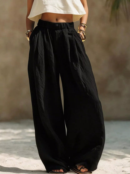 Beige plus size wide leg pants with full elastic waistband, relaxed fit, and flowing fabric, designed for comfortable style.