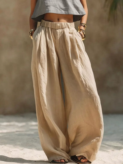 Beige plus size wide leg pants with full elastic waistband by Trendsi, featuring a relaxed fit and flowy silhouette.