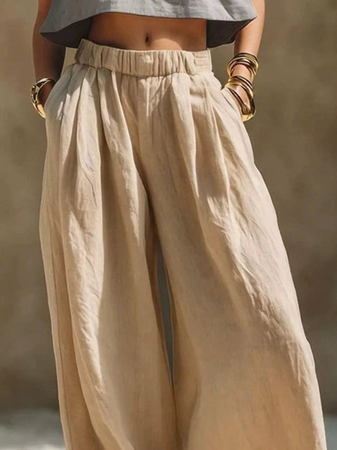 Beige plus size wide leg pants with elastic waistband from Trendsi, showcasing a relaxed fit and flowy fabric.