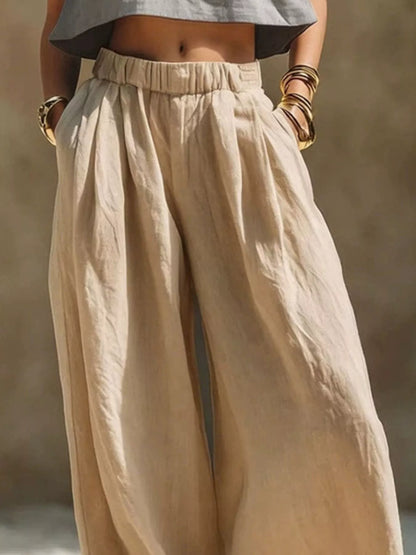 Beige plus size wide leg pants with elastic waistband from Trendsi, showcasing a relaxed fit and flowy fabric.