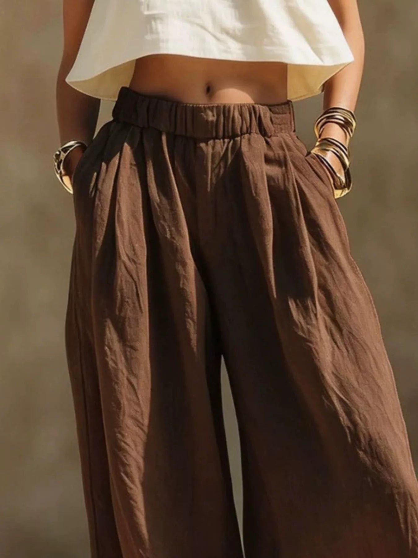Plus size beige wide-leg pants with full elastic waistband by Trendsi, relaxed fit and comfortable for everyday wear.
