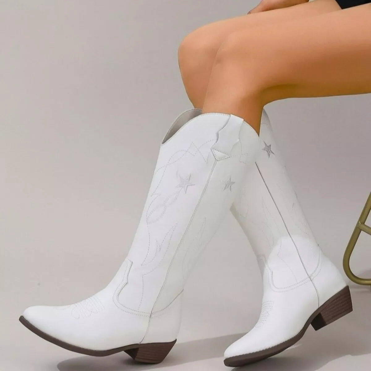 Black Western Star embroidered cowboy boots with intricate stitching and pointed toes, designed for Western-style footwear.